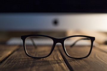 Glasses for sight and vision correction and protection from computer on the wooden table