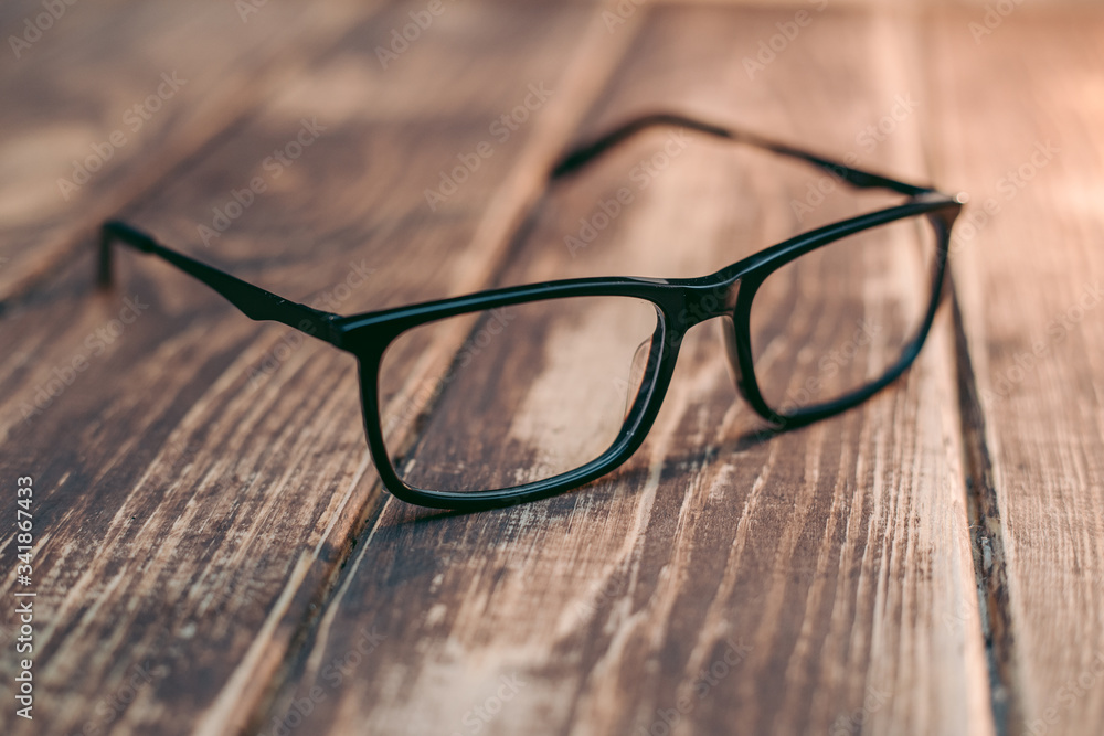 Wall mural Glasses for sight and vision correction and protection from computer on the wooden table