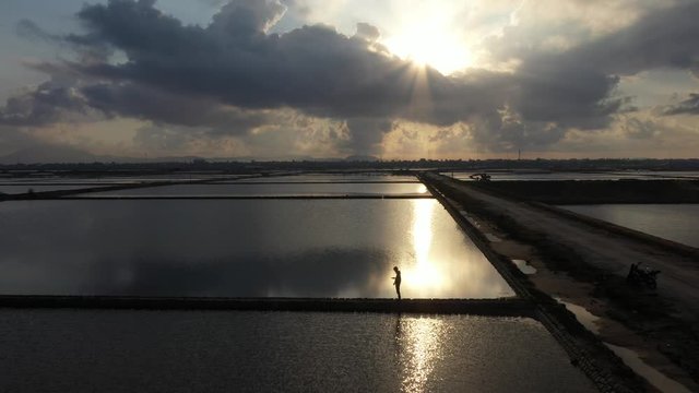 People working on Hon Khoi salt field, Khanh Hoa, Vietna. The raw white salt field on a sunny day. Free stock video footage of white salt field in a beach village. Salt is an important food for people