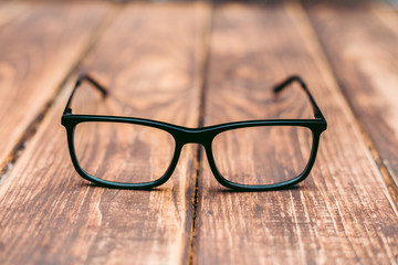 Glasses for sight and vision correction and protection from computer on the wooden table