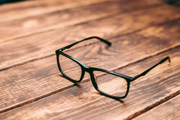 Glasses for sight and vision correction and protection from computer on the wooden table