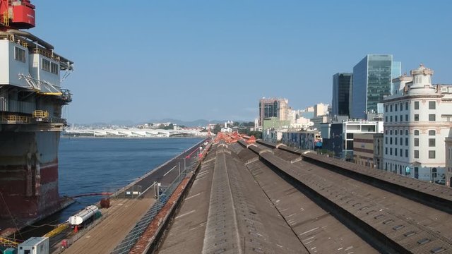 Aerial footage revealing a brick exterior warehouse in Pier Maua, Rio de Janeiro, Brazil. Birds flying and Tomorrow Museum on back. Drone dji