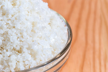 Close up of sea salt in bowl on wooden background, Sea salt is salt that is produced by the...