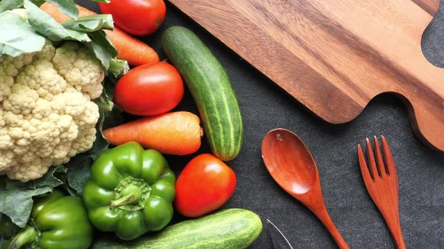 fresh vegetable on chopping board with fork and spoon 