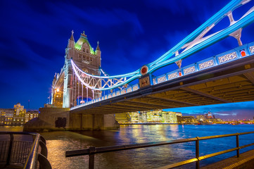 Obraz premium Famous Tower Bridge over themes river London at night London, Aerial view to the illuminated Tower Bridge and skyline of London
