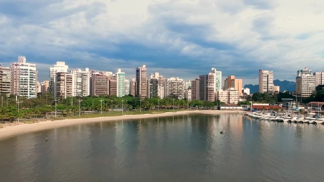 aerial footage of a sea in coast beach with buildings in a cloud nice day at Vitoria, Espirito Santo. Drone dji