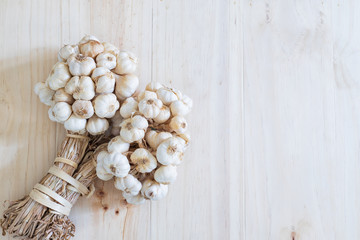 Garlic bulbs on wooden table with copy space..