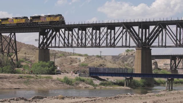 El Paso, Texas, USA. 31 May 2019. Train crossing the Rio Grande River that sits at the border of Mexico & the USA