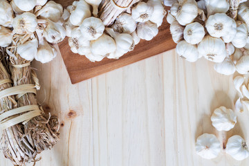 Garlic bulbs on wooden table with copy space for your text..