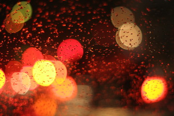 Bokeh abstract defocused lights and shadow of cityscape at rain night.