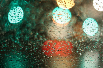 Bokeh abstract defocused lights and shadow of cityscape at rain night.