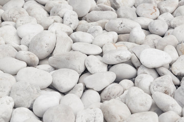 Natural backgrounds of white stones with round shape on the ground use for decoration in the garden outdoors.