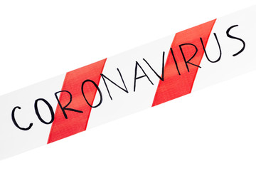 Red and white warning tape with information coronavirus on an isolated white background stretched...