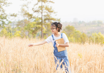 Fototapeta na wymiar Little girl playing meadow in the summer