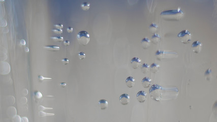 air bubbles rise in a glass with fresh sparkling water. Ultra macro close up air bubbles