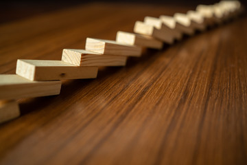 Fell dominoes on wooden table