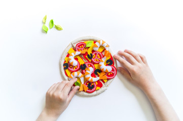 Montessori material. Felt pizza. Children's hands.