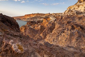 Obraz premium Beautiful panoramic views of the sea and the cliff, a mountain in the Black Sea, landscape, coastal travel and nature. Stone frozen lava of an ancient volcano