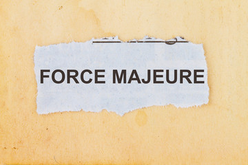Force Majeure newspaper cut out with a vintage paper background