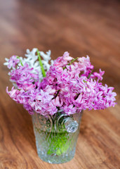 Hyacinth Flowers in a Glass Vintage Vase on a Wooden Background
