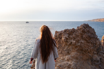 portrait of a beautiful girl with long hair on a background of white rock walking a happy child