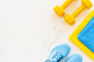 workout accessories. Sneakers, dumbbells, towel on white background top view copy space