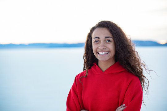 Outdoor portrait of a beautiful mixed race teenage girl. Cute diverse head and shoulders photo of a real teen girl outdoors