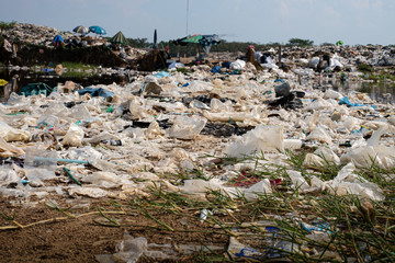 Polluted water and mountain large garbage pile and pollution, Pile of stink and toxic residue,...