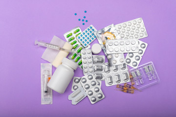 Different medicines on a lilac background. Varying drugs for different purposes. Doctor's prescription, each kind of medicine is for its purpose. Medicine is a part of our life.