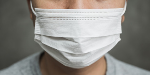 Close up young asian man wearing protection face mask against coronavirus.