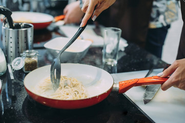Cooking pasta with seafood in a cooking class. Italian pasta with seafood. Mussels