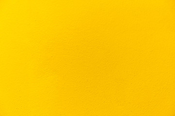 Obraz premium Blurred Yellow stucco wall background. Yellow painted cement wall texture.