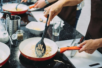 Cooking pasta with seafood in a cooking class. Italian pasta with seafood. Mussels