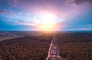 View from above of countryside and pine forest in evening. Beautiful sky at sunset