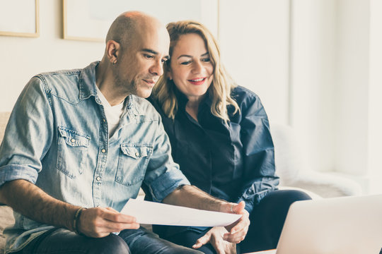 Cheerful Mature Couple Having Video Call Via Laptop. Cheerful Middle Aged People Talking About House Renovation Through Video Call. New House Project, Renovation Concept