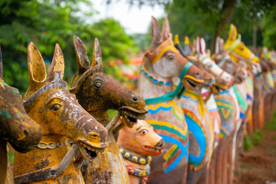 Decorative painted terracotta horses surround a temple in Narthamalai village