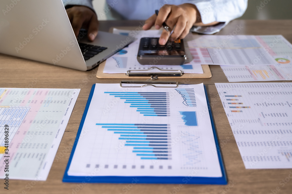Poster man usingcalculator with money stack financial report- business accounting concept accounting money 