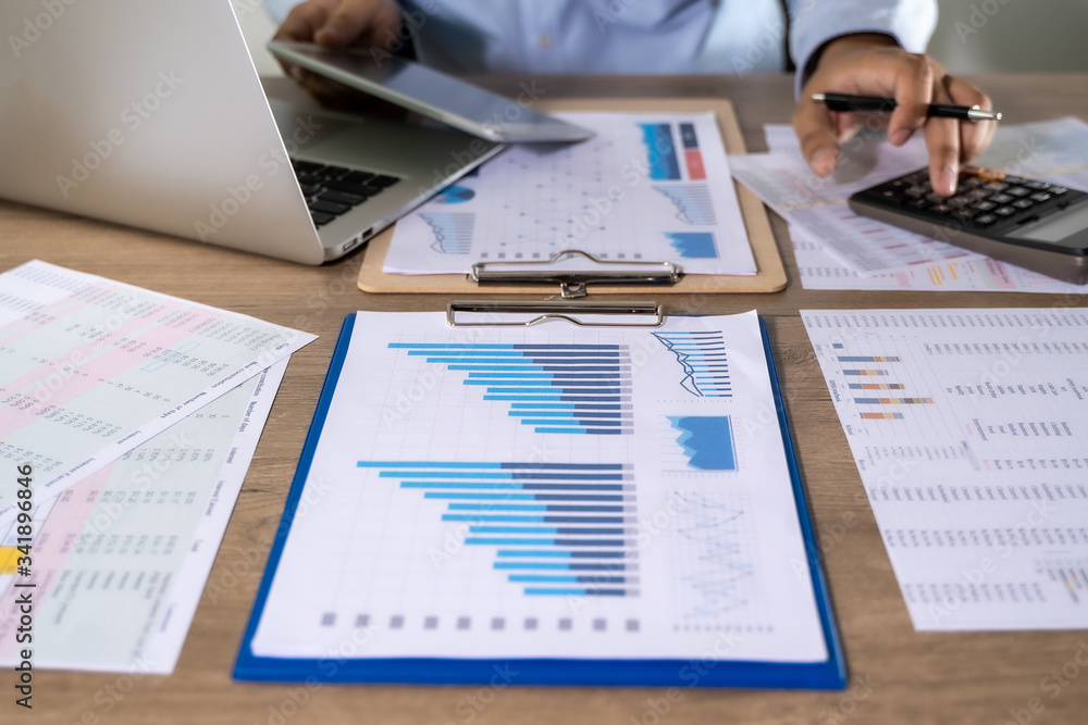 Poster man usingcalculator with money stack financial report- business accounting concept accounting money 