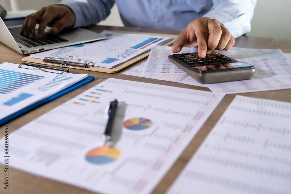 Poster man usingcalculator with money stack financial report- business accounting concept accounting money 