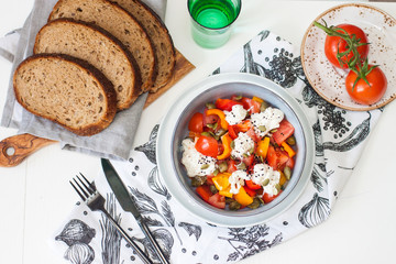 Healthy salad with grilled pepper, tomatoes, stracciatella, herbs and pumpkin seeds. Healthy eating concept.