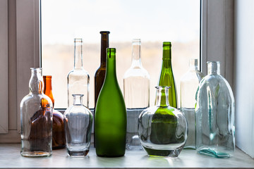 various bottles on windowsill and view of park