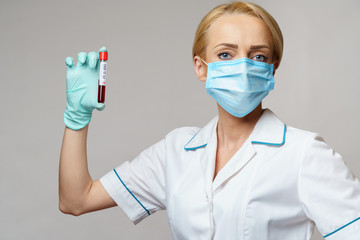 medical doctor nurse woman wearing protective mask and gloves - holding virus blood test