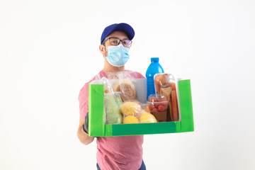 Delivery guy with protective mask holding box with groceries.