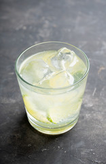 Rum based cocktail caipirinha (variation of cuba libre) on the rustic background. Selective focus. Shallow depth of field.