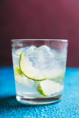 Rum based cocktail caipirinha (variation of cuba libre) on the rustic background. Selective focus. Shallow depth of field.