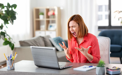 remote job, failure and stress concept - angry young woman with laptop computer working at home...