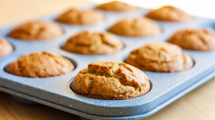 Carrot muffins in metal baking form. Homemade tasty dessert or breakfast. Healthy eating concept.  Selective focus