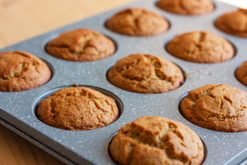Carrot muffins in metal baking form. Homemade tasty dessert or breakfast. Healthy eating concept.  Selective focus