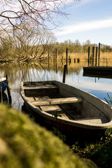 Fototapeta na wymiar row boat towed to lake shore fishing