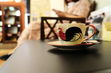 coffee cup, set on a black table Blurred background in office